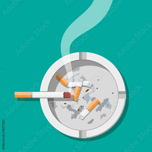 White ceramic ashtray full of smokes cigarettes.
