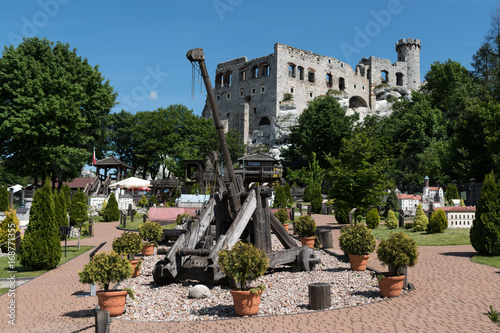 Medieval catapult made entirely of wood, Old castle Ogrodzieniec in the background 