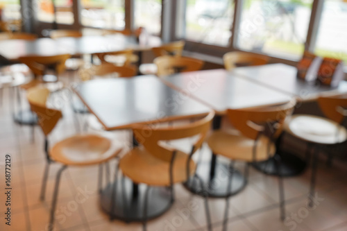 Blurred view of cafeteria with tables and chairs