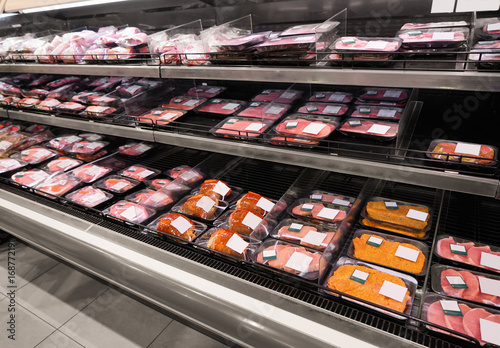 Shelves with fresh meat in supermarket