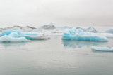 Beautiful blue icebergs with mist in glacial lagoon Jokulsarlon, South Iceland