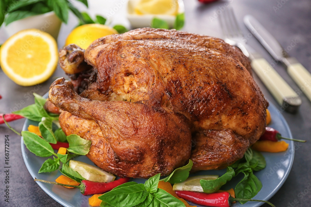 Plate with tasty whole roasted turkey on table Plate with tasty whole roasted turkey on table