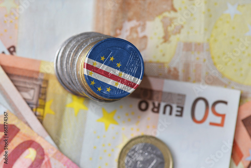 euro coin with national flag of cape verde on the euro money banknotes background.