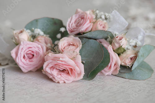 Bohemian wedding bouquet featuring dusky pink large roses and over-sized leaves 