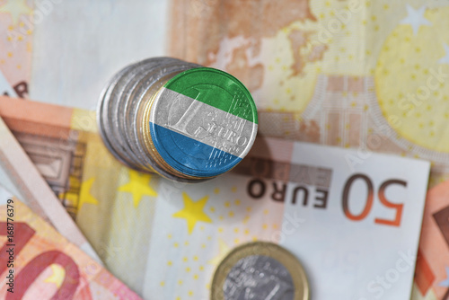 euro coin with national flag of sierra leone on the euro money banknotes background.