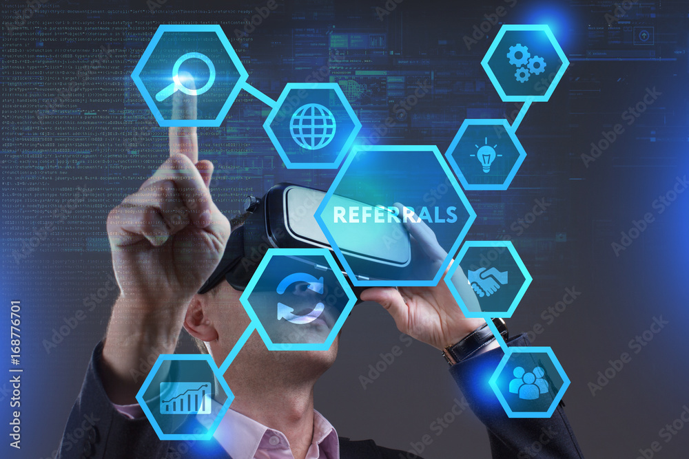 Business, Technology, Internet and network concept. Young businessman working on a virtual screen of the future and sees the inscription: Referrals Business, Technology, Internet and network concept. Young businessman working on a virtual screen of the future and sees the inscription: Referrals