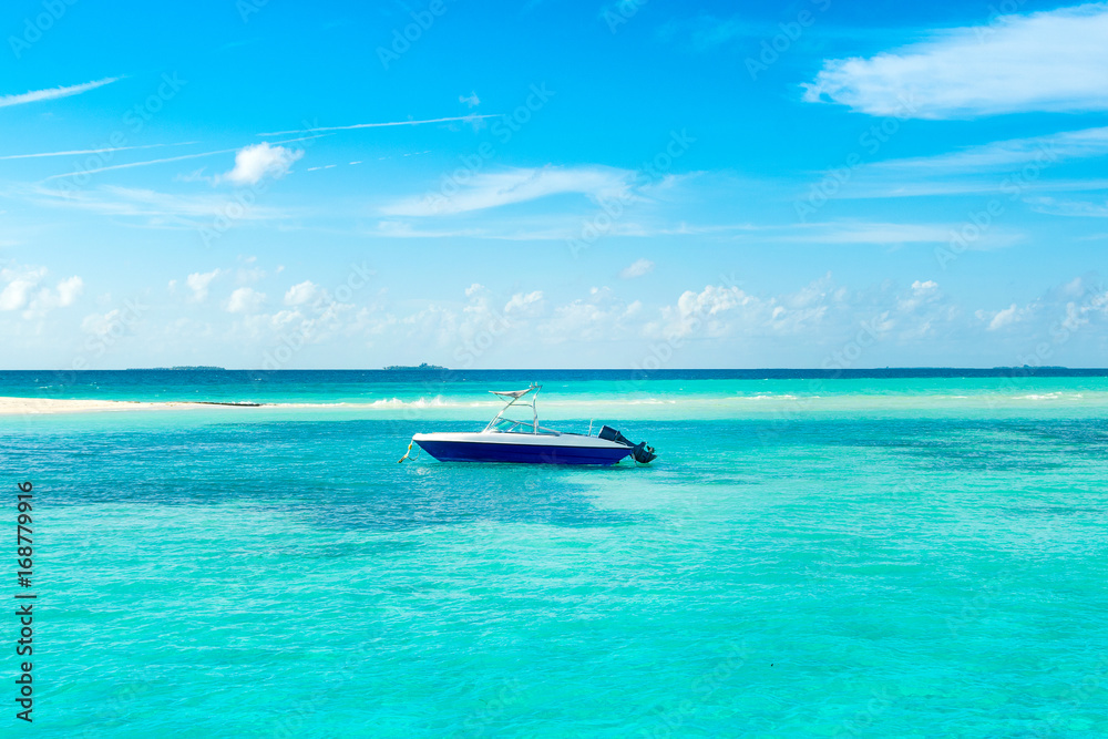 Powerboat in the crystal water of the Indian Ocean, Maldives