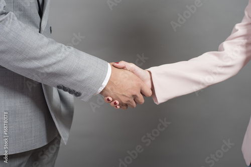 Businessman and businesswoman are shaking hands,Business plan and business meeting concept