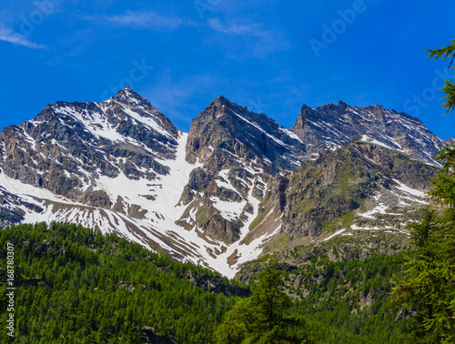 view of the Three Levanne,are the most famous  mountains in the National Park of Great Paradise,in Piedmont,Italy/  the mountains Three Leavanne with their 3500 metres height,are covered with snow