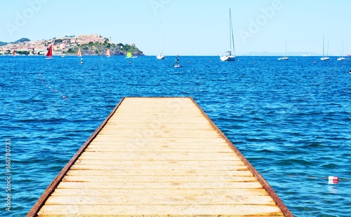 Wooden rusty bridge on the beach in Bagnaia town, Portoferraio, Elba island, Italy