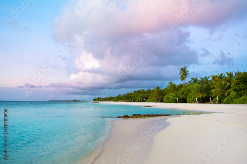 Fototapeta Naklejka Na Ścianę i Meble -  Landscape of beautiful sunset in Maldives island sandy beach with colorful sky over wavy sea