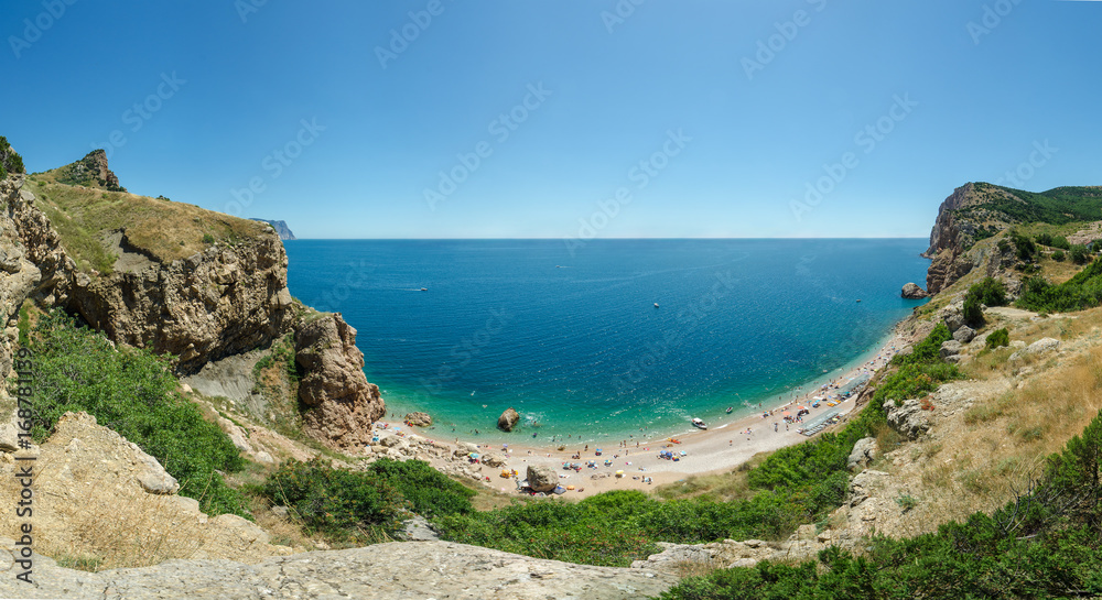 Panorama of Balaklava beach Crimea Black Sea.Blue azure seaside with corals sand and stones