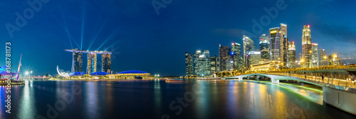 Panoramic view of Singapore business district skyline during laser show in the evening.