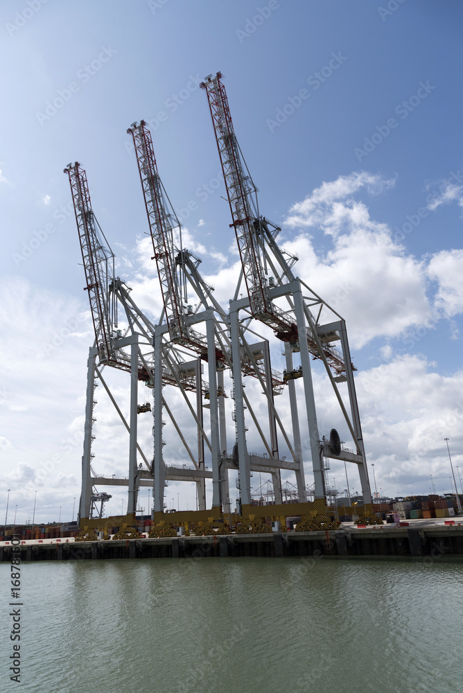 Thre cranes line the waterfront at D P World Container Terminal in Southampton Docks England UK. August 2017 Thre cranes line the waterfront at D P World Container Terminal in Southampton Docks England UK. August 2017