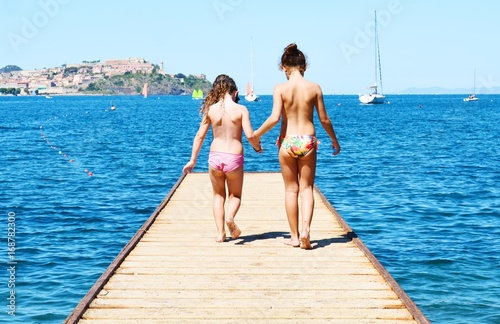 Children on wood bridge in Bagnaia town, Elba island, romantic image © damaisin1979