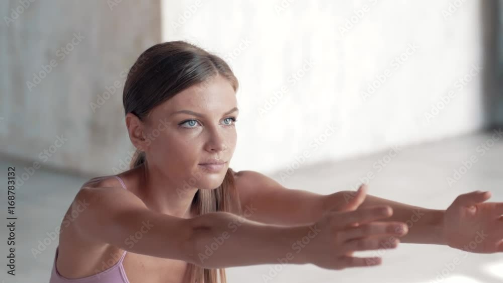 Slow-motion shooting exercises Yoga close-up. Sporty girl doing exercises on mate. Magnificent stretching and stability of the t Slow-motion shooting exercises Yoga close-up. Sporty girl doing exercises on mate. Magnificent stretching and stability of the t