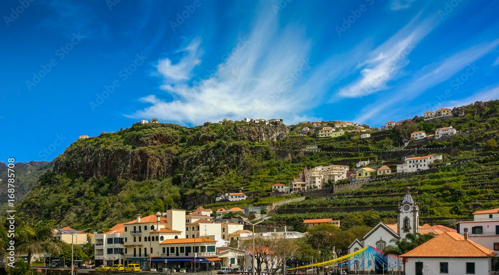 Clear blue sky over the beautiful coastal city of Tabua, on the tropical island of Madeira, Portugal.