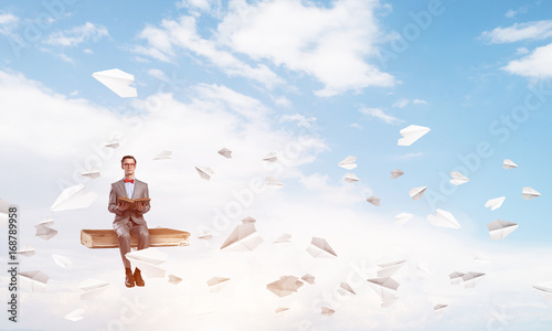 Young businessman or student in blue sky studying the science