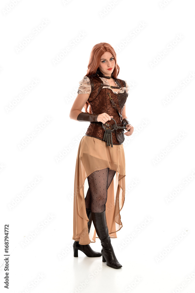 full length portrait of a red haired lady, wearing a steampunk inspired outfit, isolated  on white background.