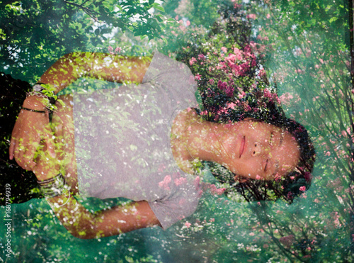 Woman sleeping and dreaming in field of flowers
