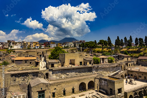 Italy. Ruins of Herculaneum (UNESCO World Heritage Site) - general view. There is Mount Vesuvius in the background photo