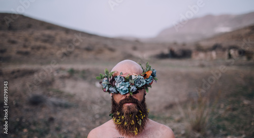 Man in desert with flower crown photo