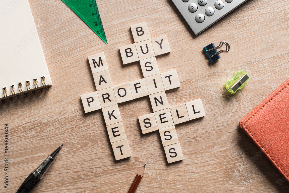 Conceptual business keywords on table with elements of game making crossword Conceptual business keywords on table with elements of game making crossword