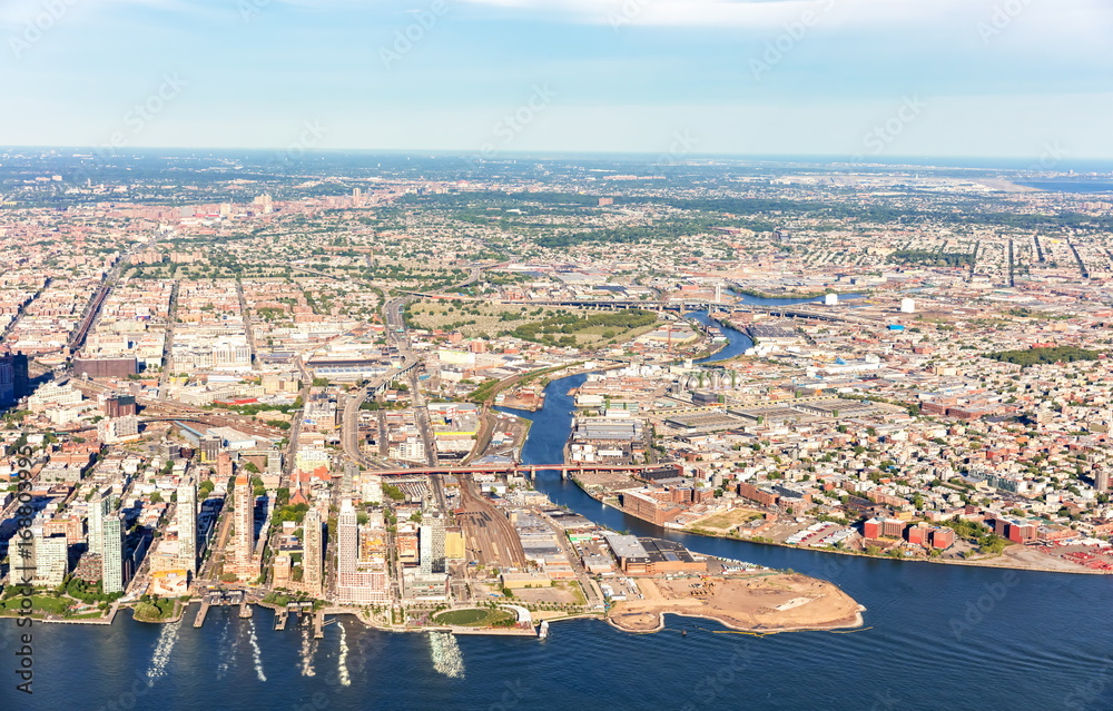 Fototapeta premium Aerial view of Brooklyn and Queens, New York City with East river in the foreground