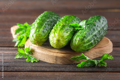 Fresh raw green cucumbers on a wooden table