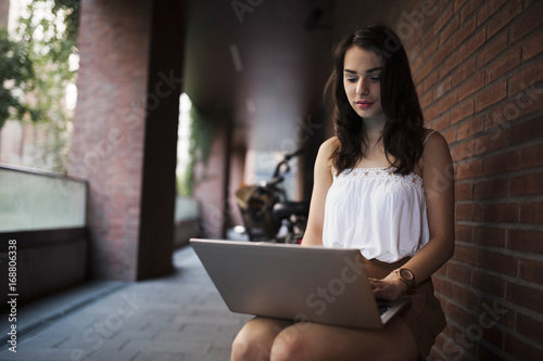 Portrait of attractive young girl using laptop