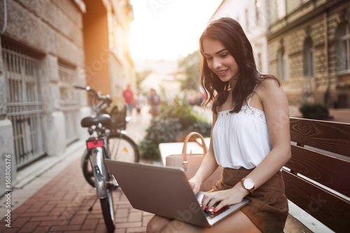 Portrait of attractive young girl using laptop