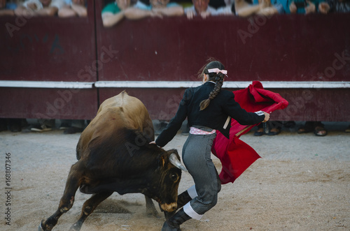 Corrida. Matador woman Fighting in a typical Spanish Bullfight photo