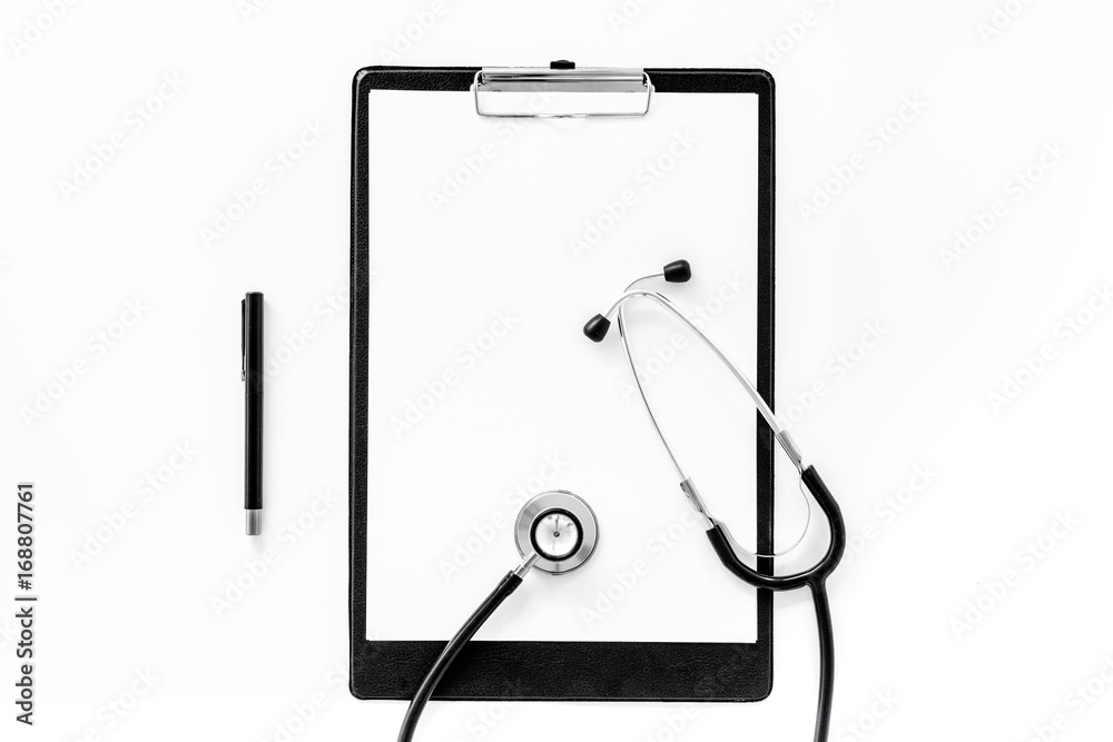 Doctor's accessories. Clip pad and stethoscope on white background top view mockup copyspace Doctor's accessories. Clip pad and stethoscope on white background top view mockup copyspace