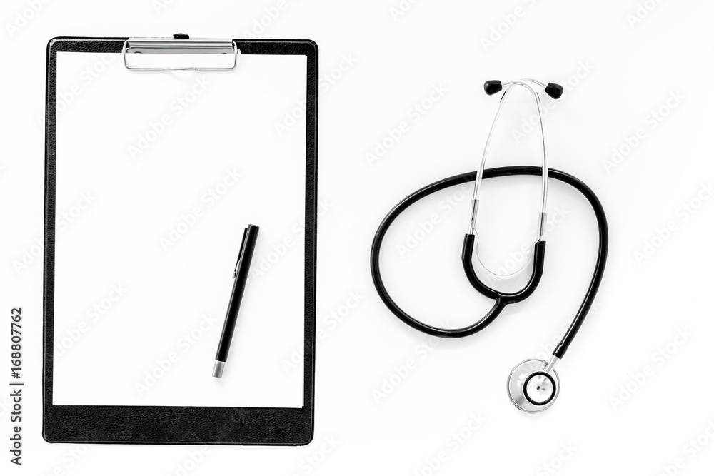 Doctor's accessories. Clip pad and stethoscope on white background top view mockup Doctor's accessories. Clip pad and stethoscope on white background top view mockup