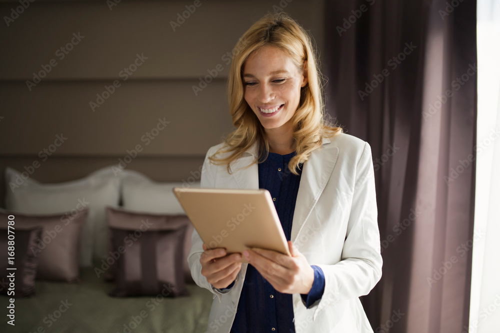 Portrait of businesswoman using tablet in hotel room Portrait of businesswoman using tablet in hotel room