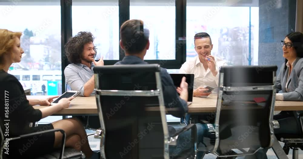 Friends or casual business group working on a project in bright corporate office