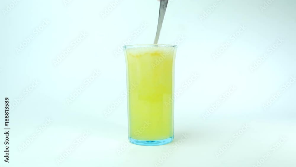 Fruit Salt (Effervescent powder) dissolving in a glass of water. Fruit Salt (Effervescent powder) dissolving in a glass of water.