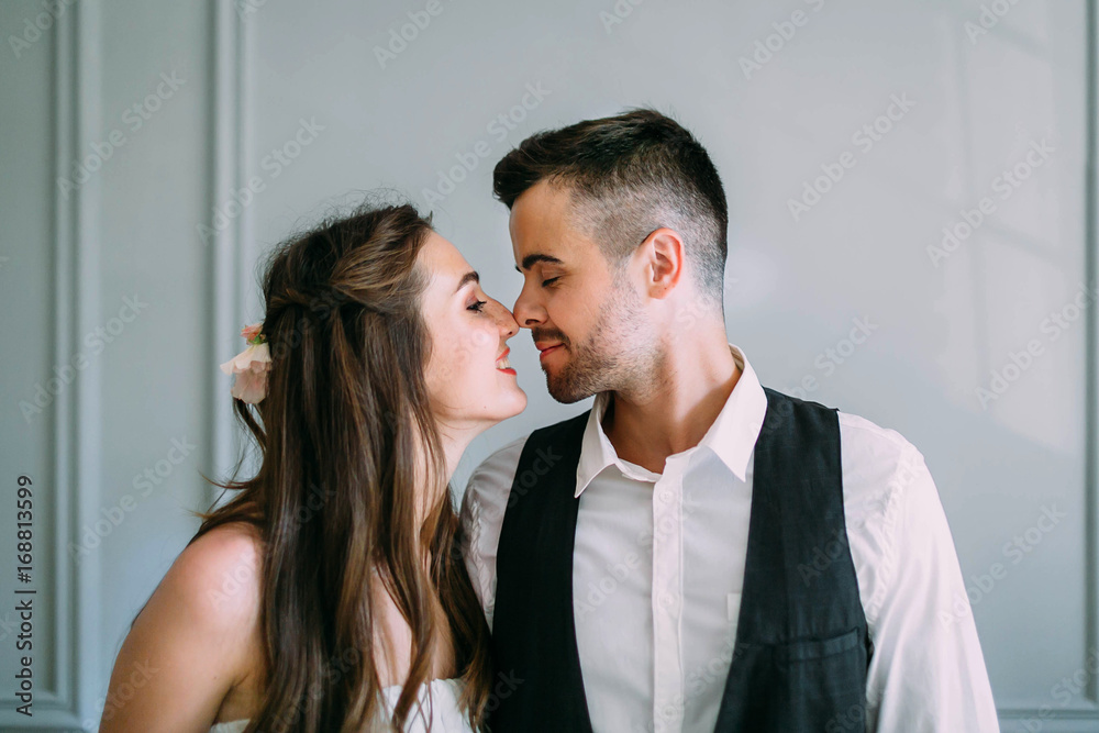 Young and happy newlyweds are touching noses