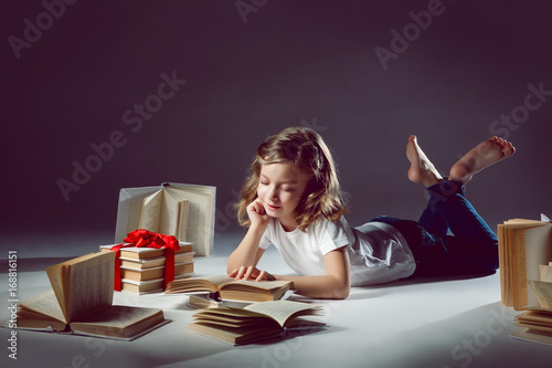 The girl rereads the textbooks. Preparation for school. photo