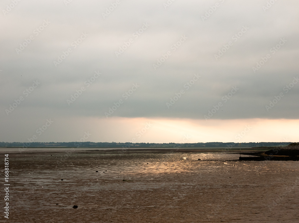 sunsetting in the distance stunning light over mudflats casting glow pretty beach sunsetting in the distance stunning light over mudflats casting glow pretty beach