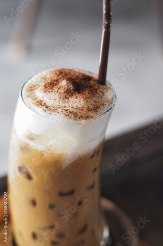 Iced latte and topping with whipped cream served in the glass .