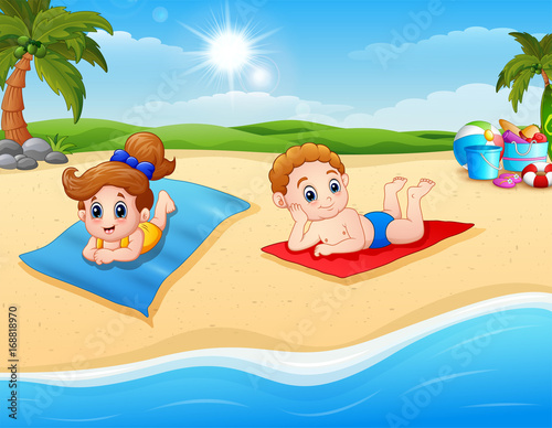 Children sunbathing on the beach mat © dreamblack46