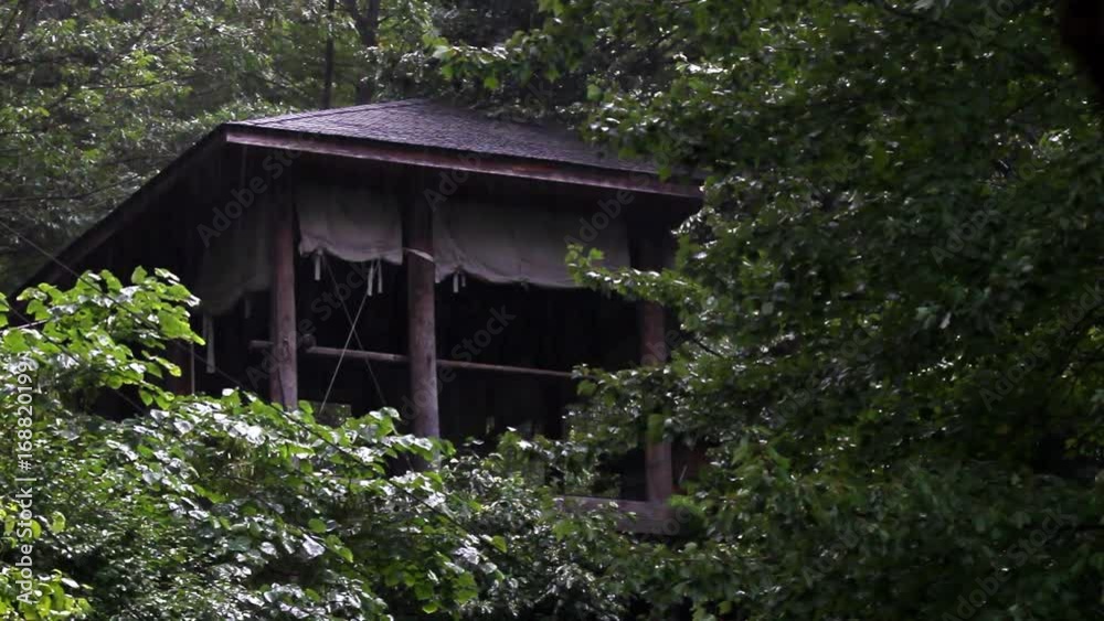 Wooden Temple in the Jungle Establishing Shot during rainstorm