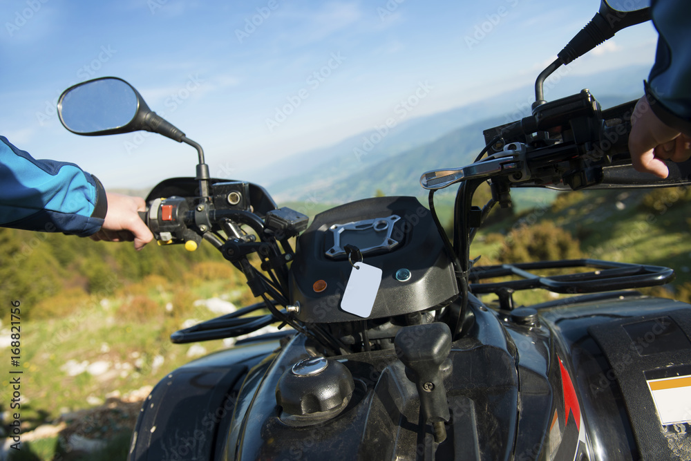Young man on quad bike on a countryside trail. View from a quad bike. Young man on quad bike on a countryside trail. View from a quad bike.