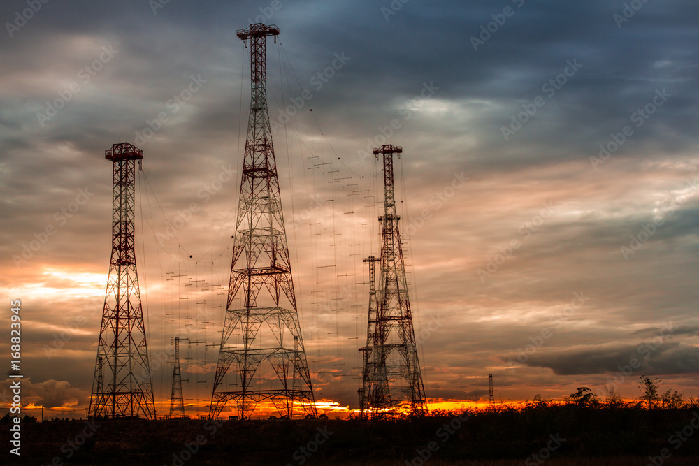 Telecommunication mast television antennas on sunset