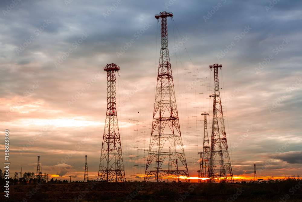 Telecommunication mast television antennas on sunset