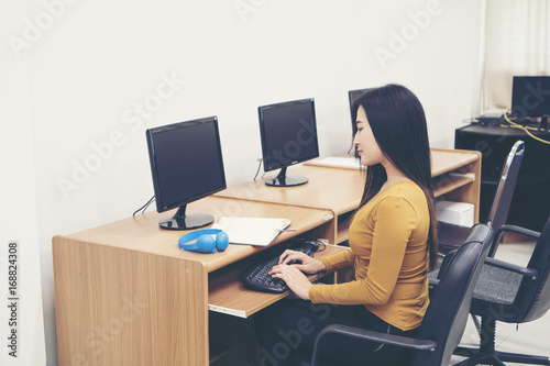 Young woman using computer at office. © Johnstocker