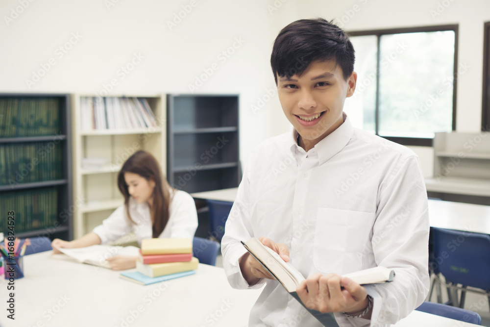Young student reading book in library . Education concept. Young student reading book in library . Education concept.