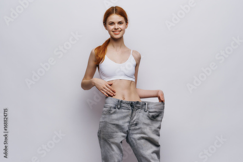 Young beautiful woman on white isolated background, slimming, diet, fitness
