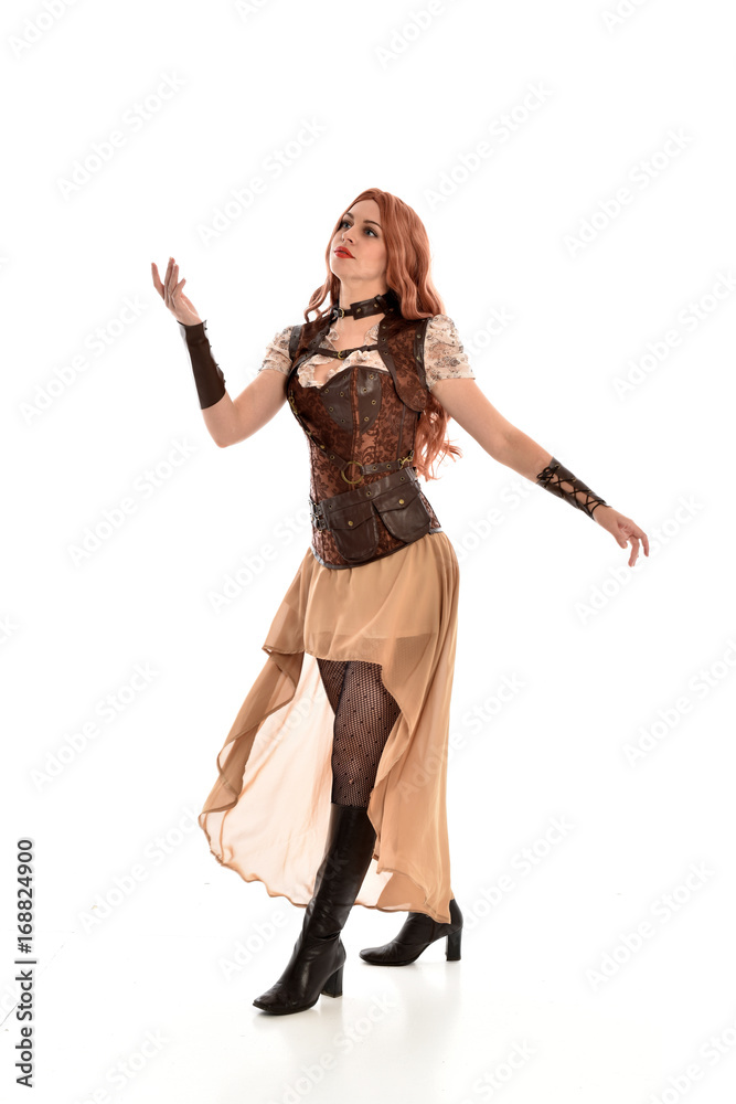 full length portrait of red haired lady wearing steampunk inspired outfit, standing pose against a white background. full length portrait of red haired lady wearing steampunk inspired outfit, standing pose against a white background.
